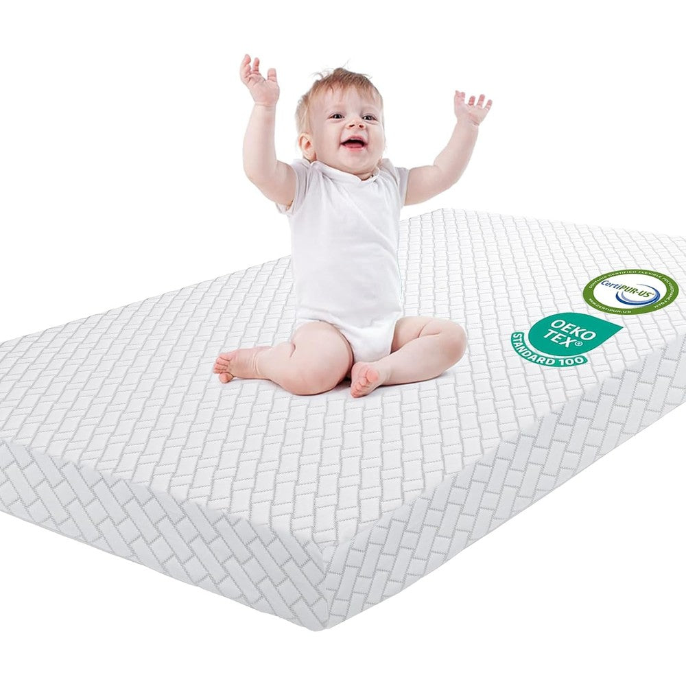 HREVAI pack and play mattress front view showing the white geometric quilted jacquard pattern.
