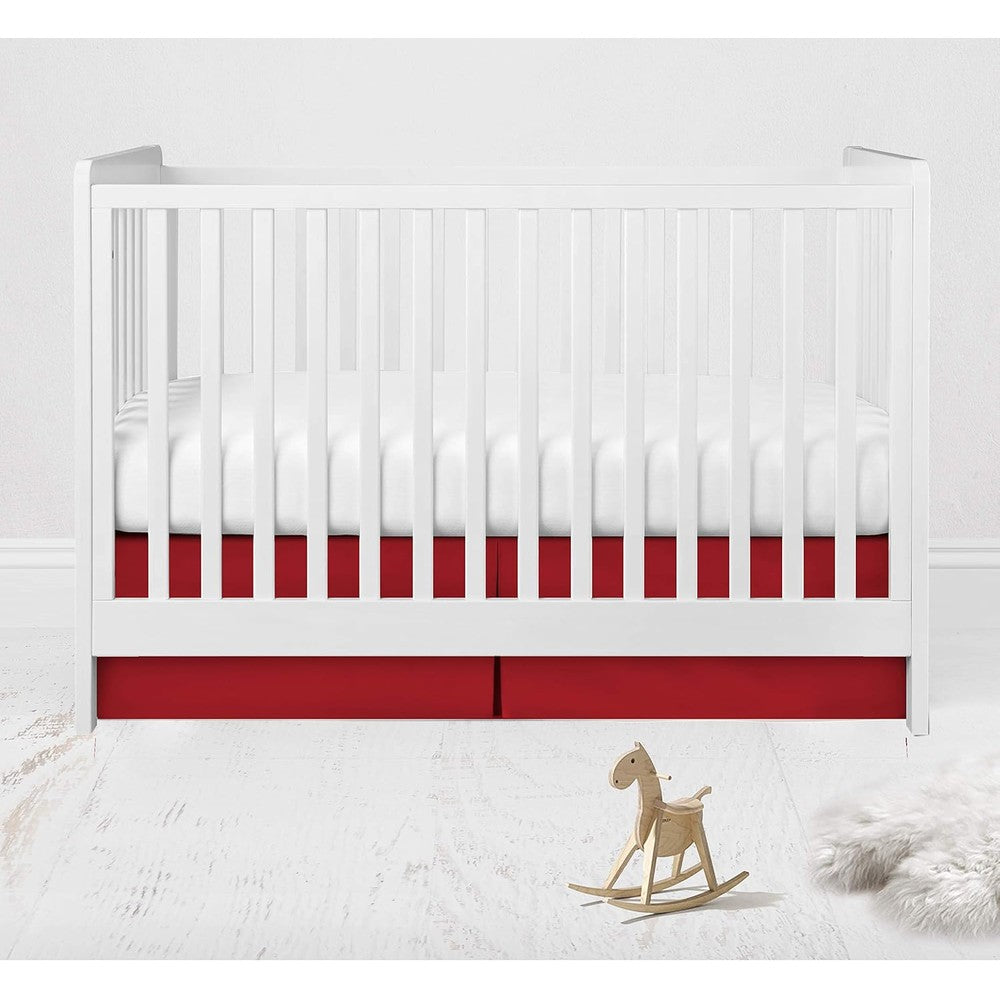 Bacati Muslin Ikat Stars Toddler Bedding red crib skirt front view installed on white baby bed