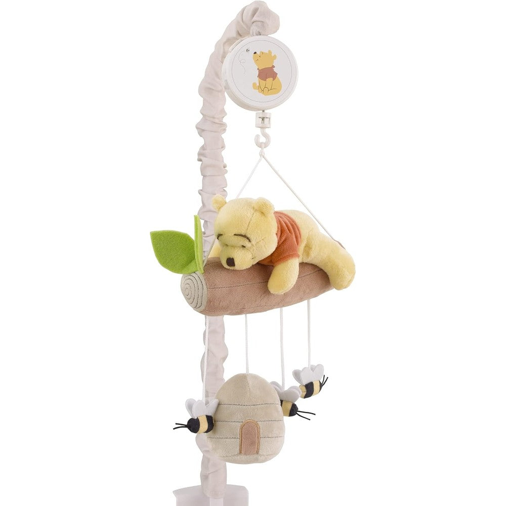 NoJo Disney Winnie the Pooh Hugs and Honeycombs musical mobile front view attached to a white baby crib