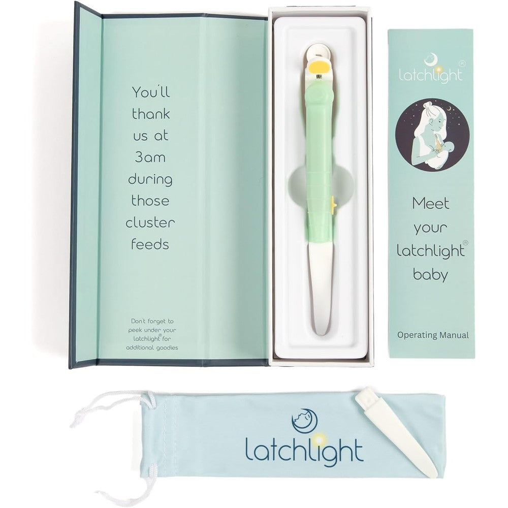 LatchLight wearable baby night light front view clipped on a nursing bra showing amber glow