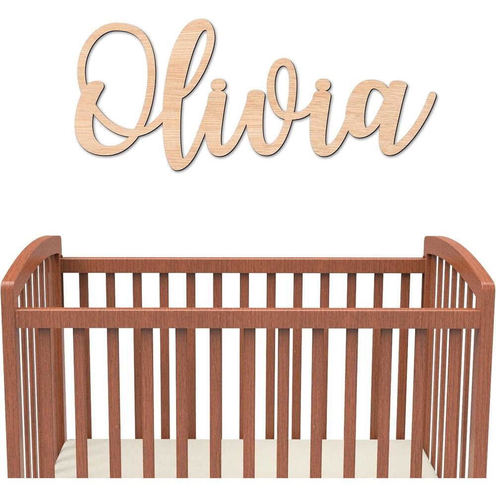 Woodland Personalized Wooden Name Sign front view displaying custom baby typography over a modern nursery crib.