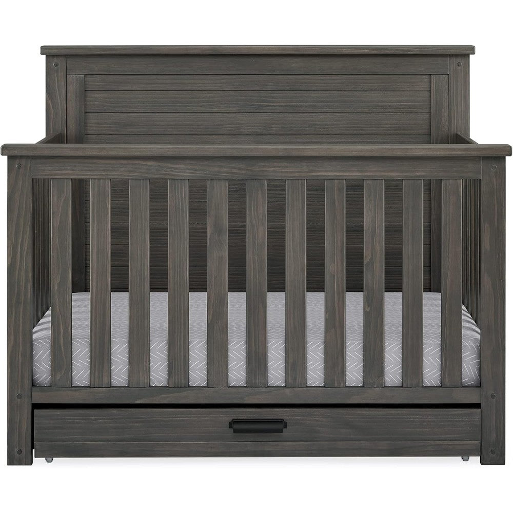 Delta Children Simmons Kids Caden convertible crib front view setup in a rustic grey modern nursery