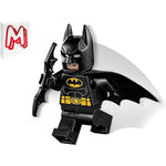 LEGO Super Heroes Batman minifigure front view in premium black suit holding a weapon.
