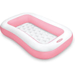 Intex Swim Center inflatable family pool front view showcasing the vibrant pink rectangular design on a garden lawn.