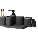 INIUNIK bathroom accessories set front view showing dark grey resin soap dispenser and toothbrush holder on vanity counter