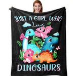Amonee-YL dinosaur blanket front view showing pink flannel throw with cartoon graphics