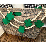 Generic Beaded St Patricks Day Garland front view hanging gracefully on a rustic white fireplace mantel.