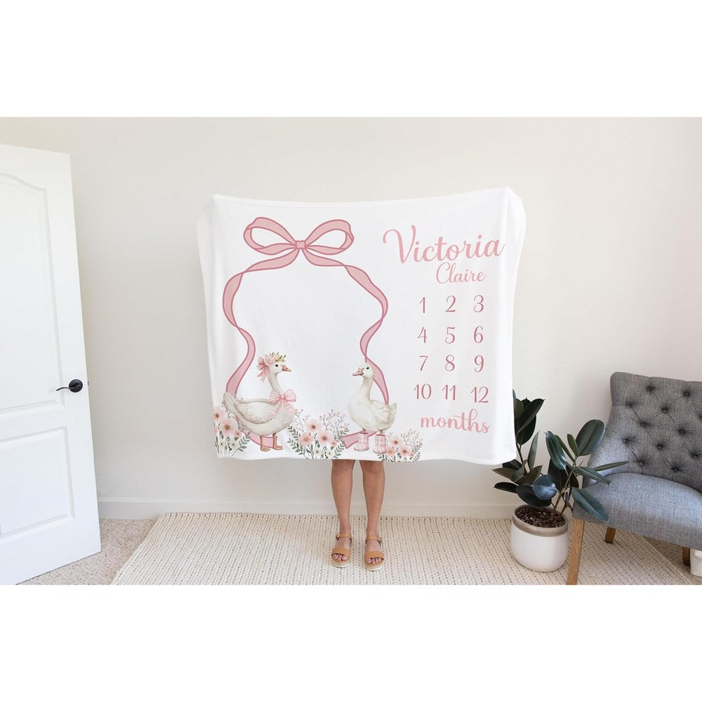 Custom personalized baby girl goose milestone blanket front view laid flat for monthly infant tracking photos.