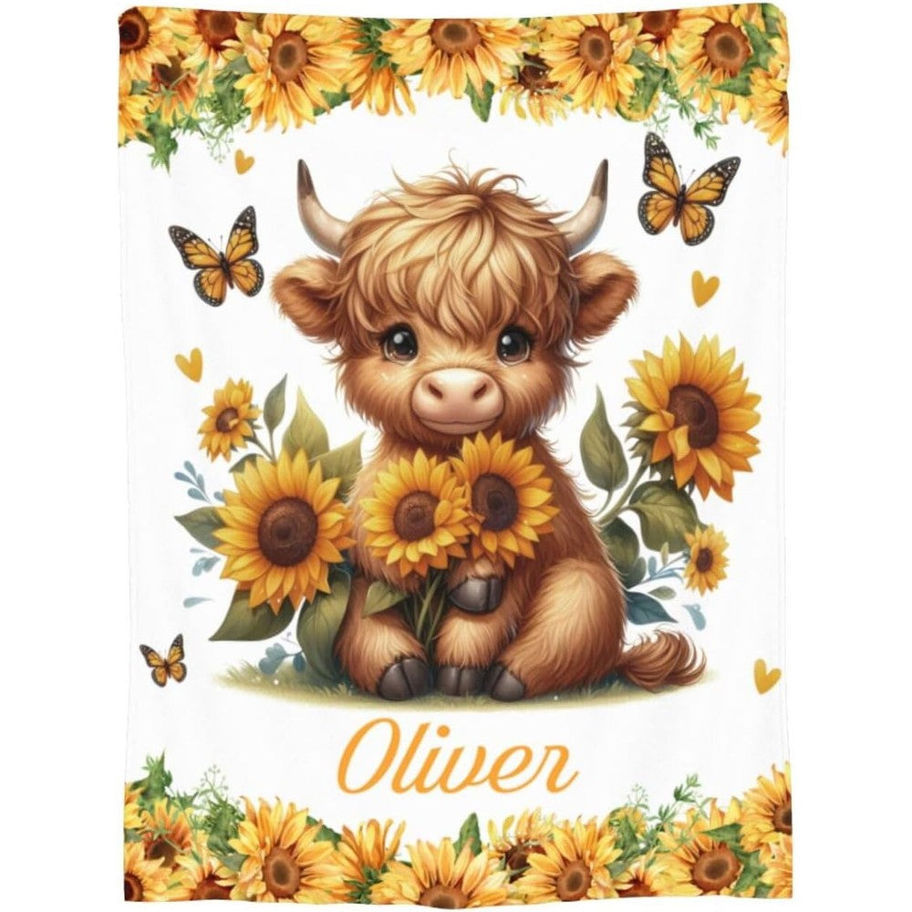 OllyandEvie custom baby highland cow blanket front view showing the personalized child name print.