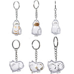 BTYYIHEX Cat Hair Keepsake Keychains front view showing transparent cat shaped memorial capsule pendants for pet fur storage.