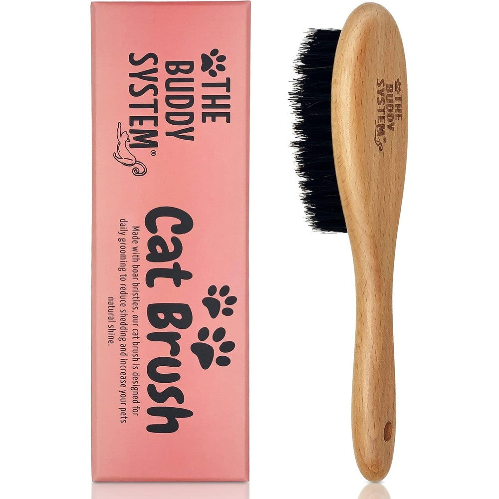 The Buddy System cat brush front view showing natural boar bristles and wooden handle packaging box