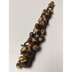 A single chocolate-covered pretzel stick topped with chopped nuts and drizzles of chocolate, photographed on a plain light background.