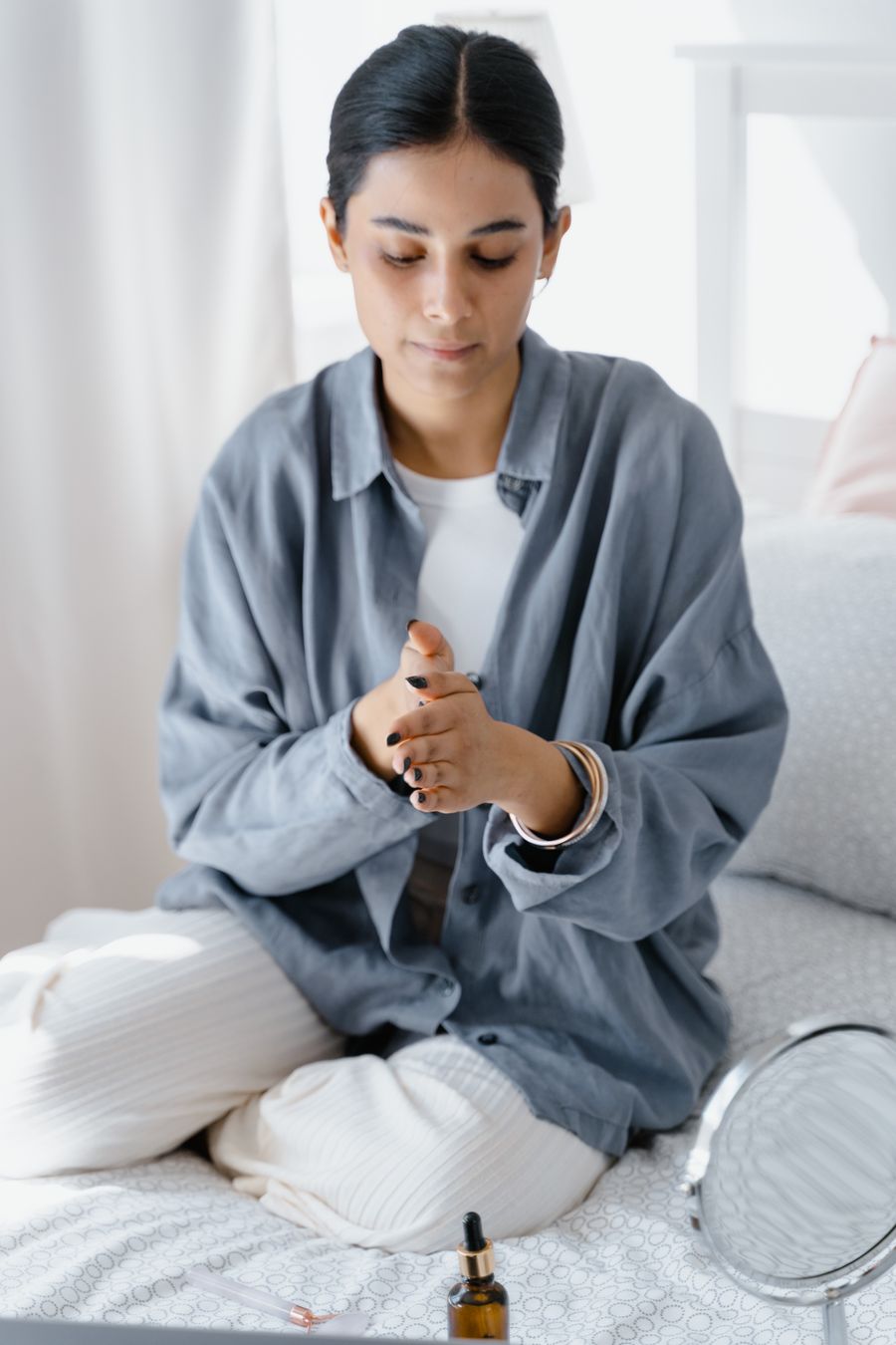 Woman warming the serum between her palms before applying